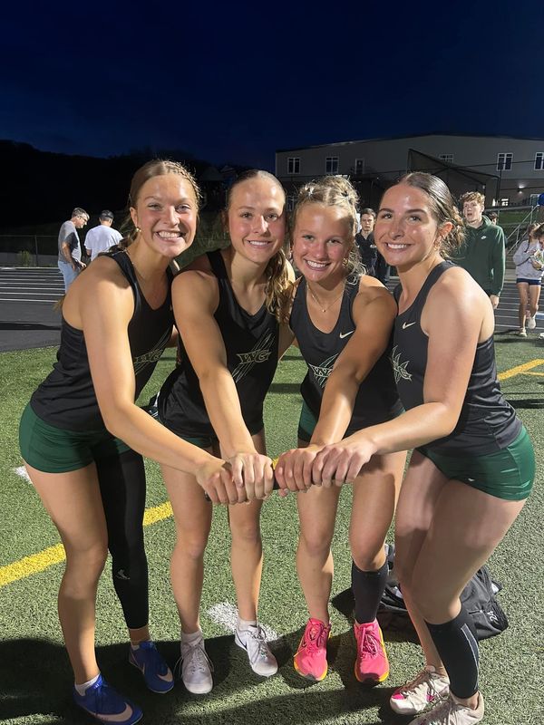 Woodward-Granger's Jaidyn Achenbach, Kristyn Crouse, Andrea Nardini and Hayden Thomas pose for a photo after breaking the school record in the 4x100 during the West Central Activities Conference Meet on Tuesday, May 6, 2025, at Des Moines Christian School.