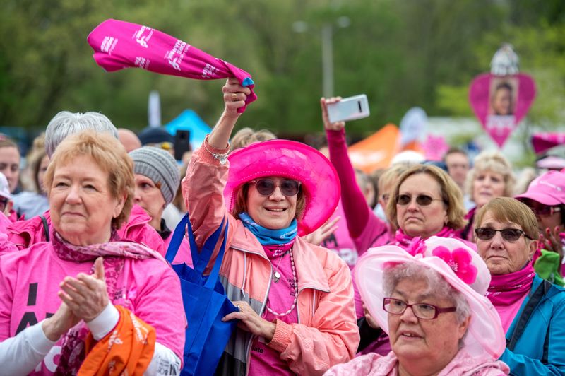 MATT DAYHOFF/JOURNAL STAR
Chris Becker, in hat, of Morton waves her pink wrap during the opening ceremony of the More Than Pink Walk on Saturday, May 11, 2019 at the Metro Centre in Peoria.