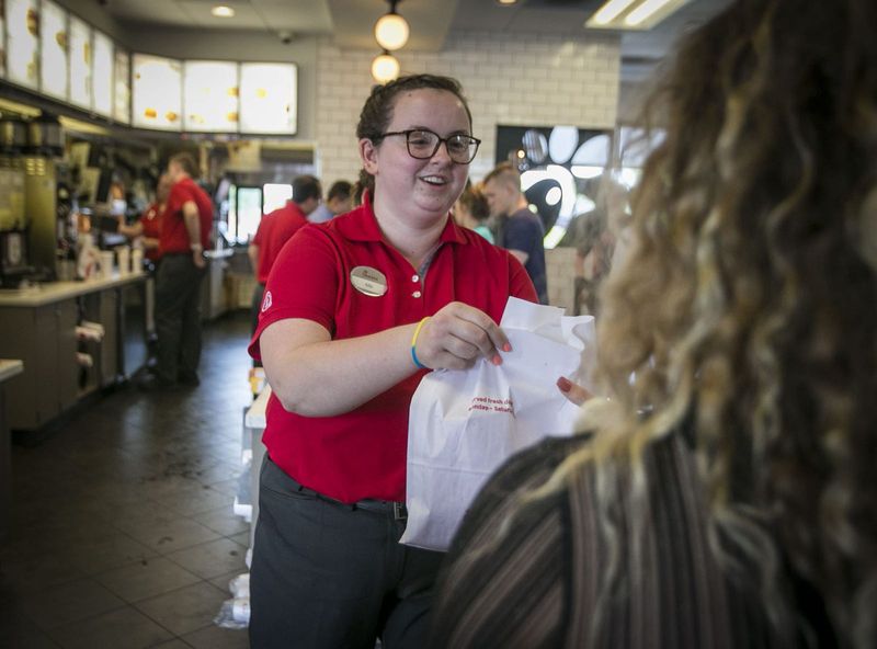 Chick-Fil-A employee, Ally Goble, delivers to a customer, May 16, 2019, at the Noblesville store off of Bergen Blvd.