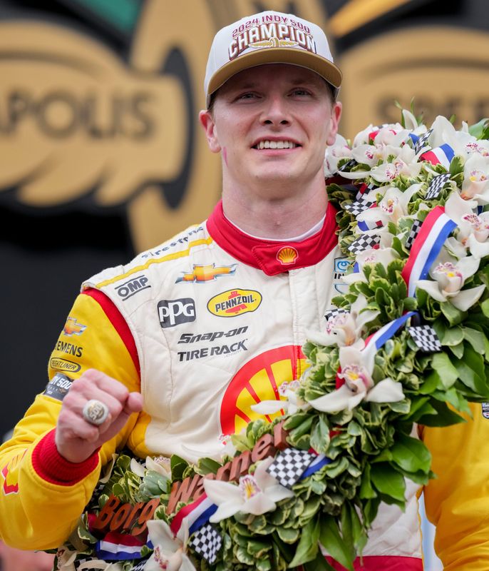 Team Penske driver Josef Newgarden (2) celebrates on the victory podium Sunday, May 26, 2024, after winning the 108th running of the Indianapolis 500 at Indianapolis Motor Speedway.