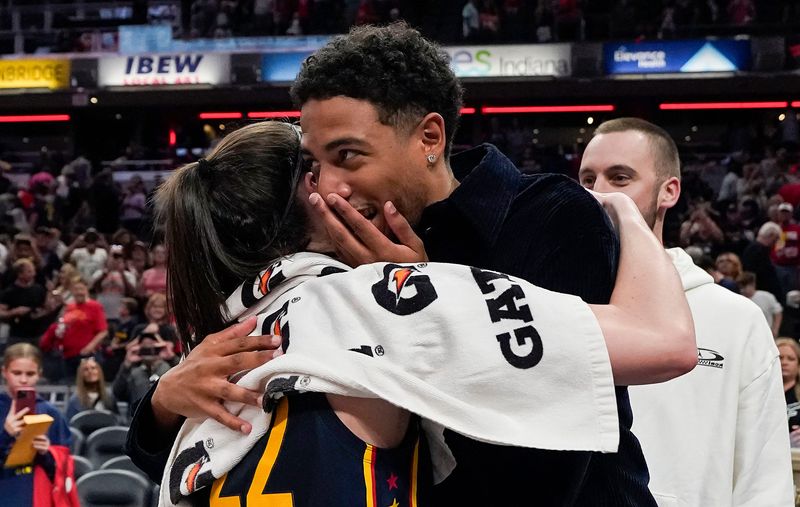 Indiana Fever guard Caitlin Clark (22) hugs Indiana Pacers Tyrese Haliburton (0) on Wednesday, Sept. 4, 2024, after the game at Gainbridge Fieldhouse in Indianapolis. The Indiana Fever defeated the Los Angeles Sparks, 93-86.