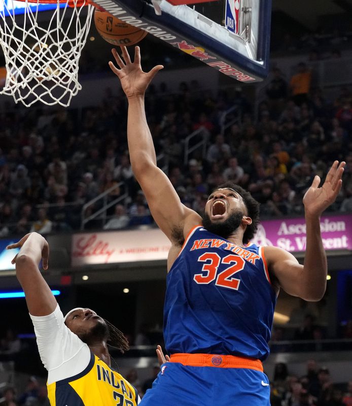 Indiana Pacers center Myles Turner (33) guards New York Knicks center Karl-Anthony Towns (32) as he shoots the ball during the first half of a game Sunday, Nov. 10, 2024, at Gainbridge Fieldhouse in Indianapolis. The Pacers defeated the Knicks 132-121.