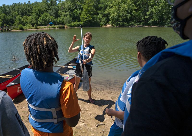 Josie Heidlage, with Camptown, tells how to change direction with oar movement, before this group canoes Thursday, June 30, 2022 at Fort Harrison State Park. Share LT students from Belzer Middle School and Fall Creek Valley Middle School canoed, fished, hiked and did a creek study with Camptown.
