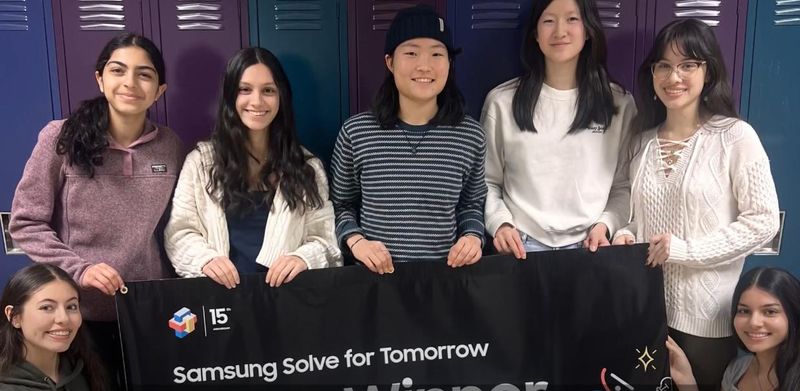 The seven student team behind STORM SHIELD poses in front of a Samsung Solve for Tomorrow banner at Bloomington High School South.