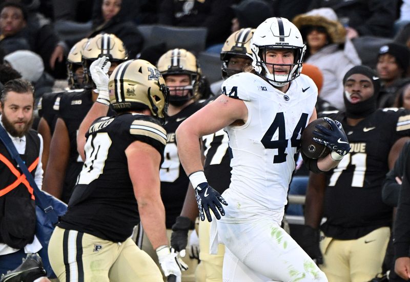 Nov 16, 2024; West Lafayette, Indiana, USA; Penn State Nittany Lions tight end Tyler Warren (44) looks at Purdue Boilermakers linebacker Hudson Miller (40) during the first quarter at Ross-Ade Stadium. Mandatory Credit: Marc Lebryk-Imagn Images