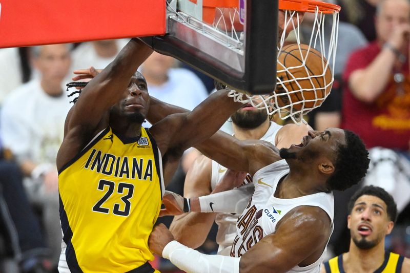 May 6, 2025; Cleveland, Ohio, USA; Indiana Pacers forward Aaron Nesmith (23) dunks beside Cleveland Cavaliers guard Donovan Mitchell (45) in the fourth quarter during game two of the second round of the 2025 NBA Playoffs at Rocket Arena. Mandatory Credit: David Richard-Imagn Images