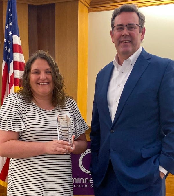 Maleah Parrish, a first-grade teacher at Daleville Elementary School, received the Ball Brothers Foundation's Excellence in Teaching Award from Jud Fisher.