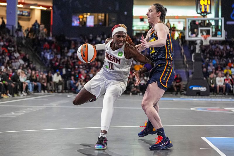 May 10, 2025; Atlanta, GA, USA; Atlanta Dream guard Rhyne Howard (10) is fouled by Indiana Fever guard Caitlin Clark (22) during the first half at Gateway Center Arena @ College Park.