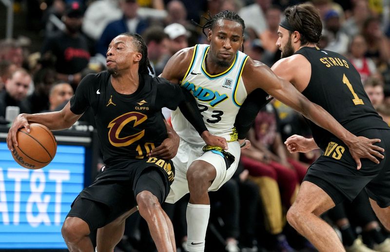 Indiana Pacers forward Aaron Nesmith (23) guards Cleveland Cavaliers guard Darius Garland (10) and guard Max Strus (1) during the second half Sunday, May 11, 2025, of Game 4 of the NBA Eastern Conference semifinals at Gainbridge Fieldhouse in Indianapolis. The Pacers defeated the Cavaliers 129-109.
