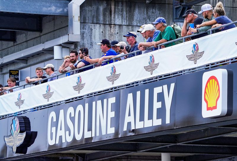Fans and photographers watch as cars head out to pit lane on Tuesday, May 13, 2025, during practice for the 109th running of the Indianapolis 500 at Indianapolis Motor Speedway.