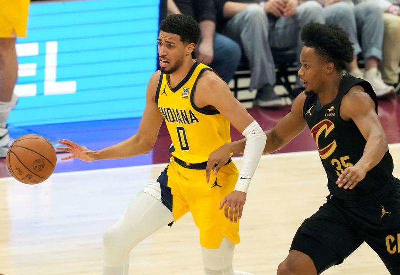 Cleveland Cavaliers forward Isaac Okoro (35) guards Indiana Pacers guard Tyrese Haliburton (0) during the first half of Game 5 of the NBA Eastern Conference semifinals on Tuesday, May 13, 2025, at Rocket Arena in Cleveland, Ohio. The Pacers defeated the Cavaliers 114-105.