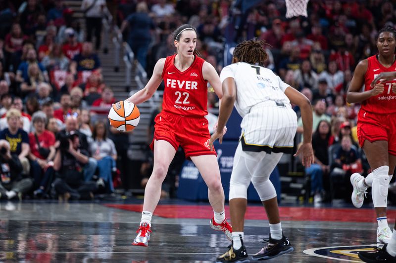 May 17, 2025; Indianapolis, Indiana, USA; Indiana Fever guard Caitlin Clark (22) dribbles the ball while Chicago Sky guard Ariel Atkins (7) defends in the first half at Gainbridge Fieldhouse. Mandatory Credit: Trevor Ruszkowski-Imagn Images
