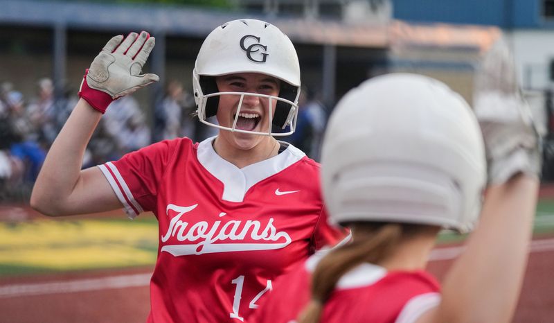 Center Grove Trojans Taylor Barrett (14) high-fives a teammate on Wednesday, May 28, 2025, during the IHSAA sectional championship game at Moorseville High School, in Mooseville.