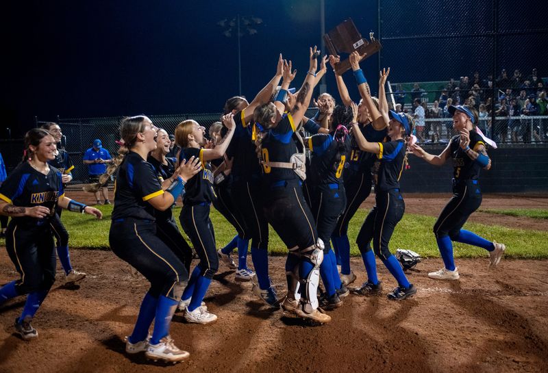 The Castle Knights celebrate with their trophy after beating the North Huskies 9-4 in the IHSAA Class 4A Softball Sectional championship game at North High School in Evansville, Ind., Thursday, May 29, 2025.