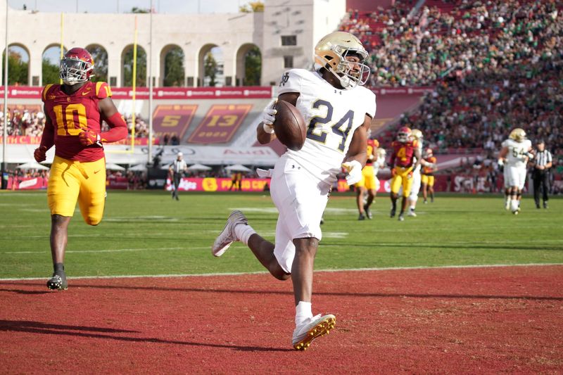 Nov 30, 2024; Los Angeles, California, USA; Notre Dame RB Jadarian Price (24) scores on a 36-yard touchdown run against the Southern California Trojans in the second half at United Airlines Field at Los Angeles Memorial Coliseum. Mandatory Credit: Kirby Lee-Imagn Images