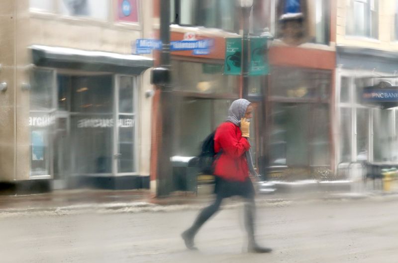 Pedestrians cross Michigan Avenue in Kalamazoo, Mich.,on Tuesday, March 3, 2015. The National Weather Service has issued a winter weather advisory for Southwest Michigan, effective Tuesday. The advisory, which is effective from 7 a.m. to 8 p.m., calls for snow, freezing rain and sleet. A total of 1 to 3 inches of snow is expected to fall and quickly mix with sleet and freezing rain, the NWS said. (AP Photo/Kalamazoo Gazette-MLive Media Group, Mark Bugnaski) ALL LOCAL TELEVISION OUT; LOCAL TELEVISION INTERNET OUT (REV-SHARE) MBI