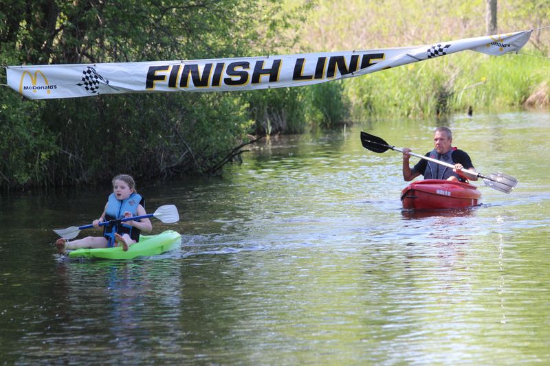 Kayakers make their way across the finish line in downtown Jonesville on Saturday, May 18, 2024, during Riverfest.