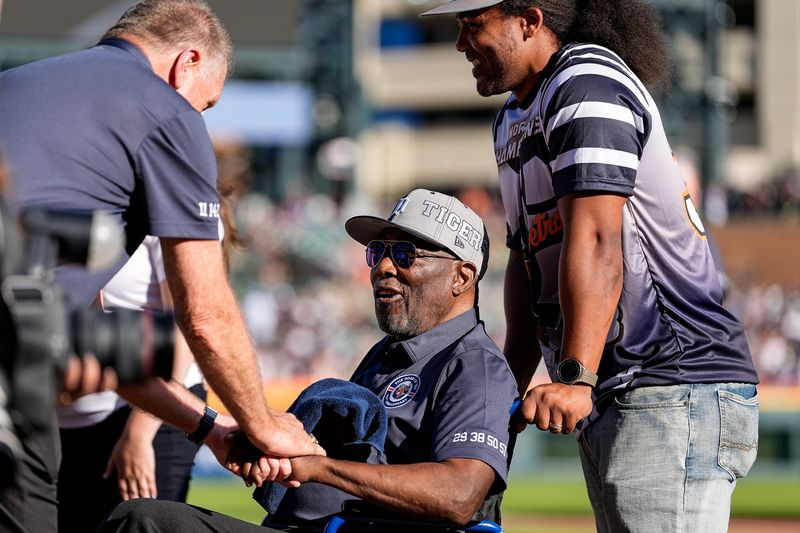 Chet Lemon, center, with his son Marcus Lemon, shakes hands with his teammate Dan Petry as Detroit Tigers honor the 1984 World Series team at Comerica Park in Detroit on Saturday, August 31, 2024.