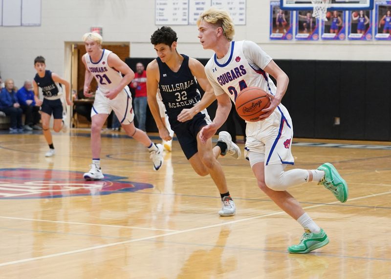 Lenawee Christian's Jaxon Salenbien pushes the ball up the floor during a game at home against Hillsdale Academy.