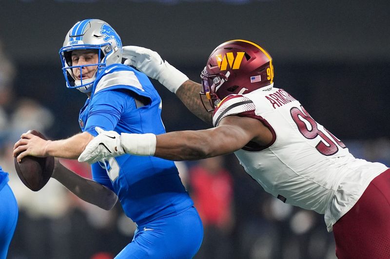 Detroit Lions quarterback Jared Goff (16) looks to avoid Washington Commanders defensive end Dorance Armstrong (92) in the first half against the Washington Commanders in the NFC divisional round at Ford Field in Detroit on Saturday, Jan. 18, 2025.