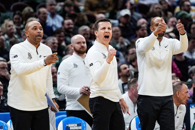 From left, Michigan State assistant coaches Thomas Kelley, Jon Borovich, and Saddi Washington celebrate a play against Bryant during the second half of the First Round of NCAA Tournament at Rocket Arena in Cleveland, Ohio on Friday, March 21, 2025.