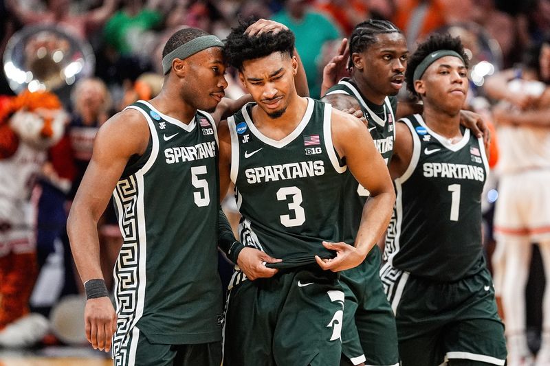Michigan State guard Jaden Akins (3) is comforted by 
guard Tre Holloman (5) after 70-64 loss to Auburn at the Elite Eight round of NCAA tournament at State Farm Arena in Atlanta, Ga. on Sunday, March 30, 2025.