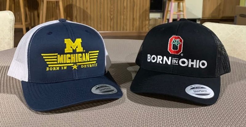 Born in Detroit is partnering with The Purple Rose Theatre Company to sell University of Michigan and Ohio State University hats during its production of "My Mother and the Michigan/Ohio War."