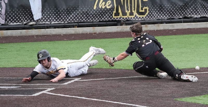 Adrian College's Jake Burns (Tecumseh) slides into home during a game against Alma College.