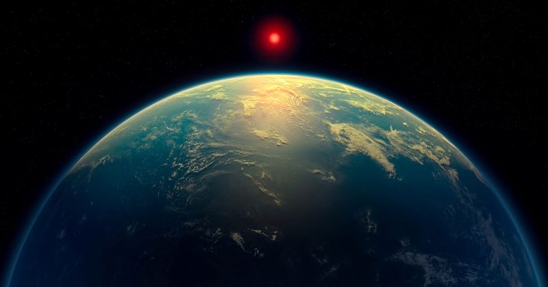 An illustration shows a hycean world – an exoplanet with a liquid water ocean beneath a hydrogen-rich atmosphere - orbiting a red dwarf star. Based on observations by the James Webb Space Telescope, the exoplanet K2-18 b might fit in this category.