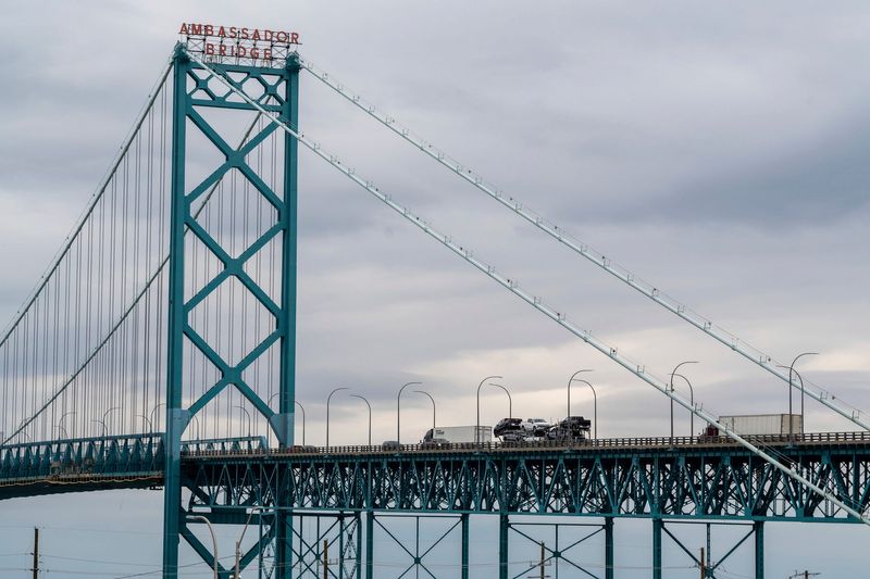A car hauler transporting vehicles crosses the Ambassador Bridge in Detroit on Thursday, March 27, 2025.