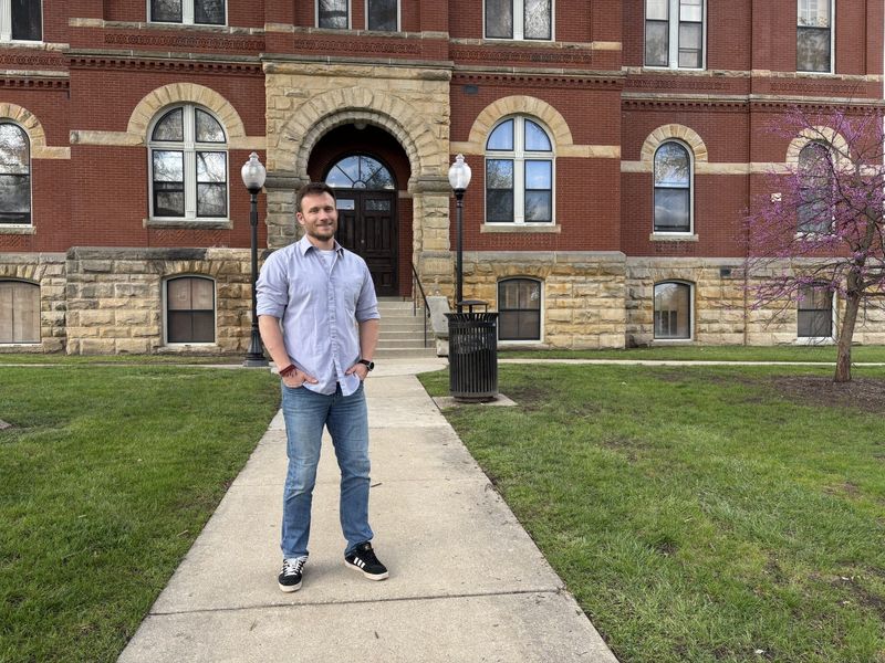 Howell City Councilmember Nikolas Hertrich stands outside the historic courthouse in downtown Howell.