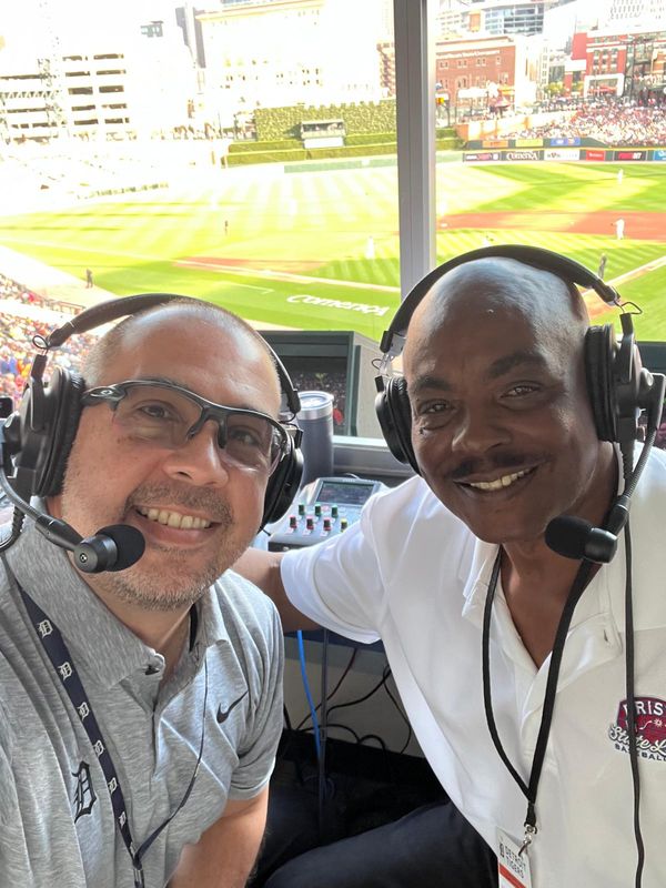 The Tigers' Spanish-language broadcasting duo of Carlos Guillén and Barbaro Garbey pose in the broadcast booth at Comerica Park in Detroit.