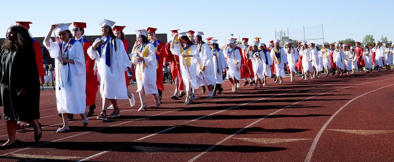 Monroe High School graduates in procession for a previous commencement ceremony. Area high schools will soon hold commencement for the Class of 2025. 
[TOM HAWLEY/MONROE NEWS]