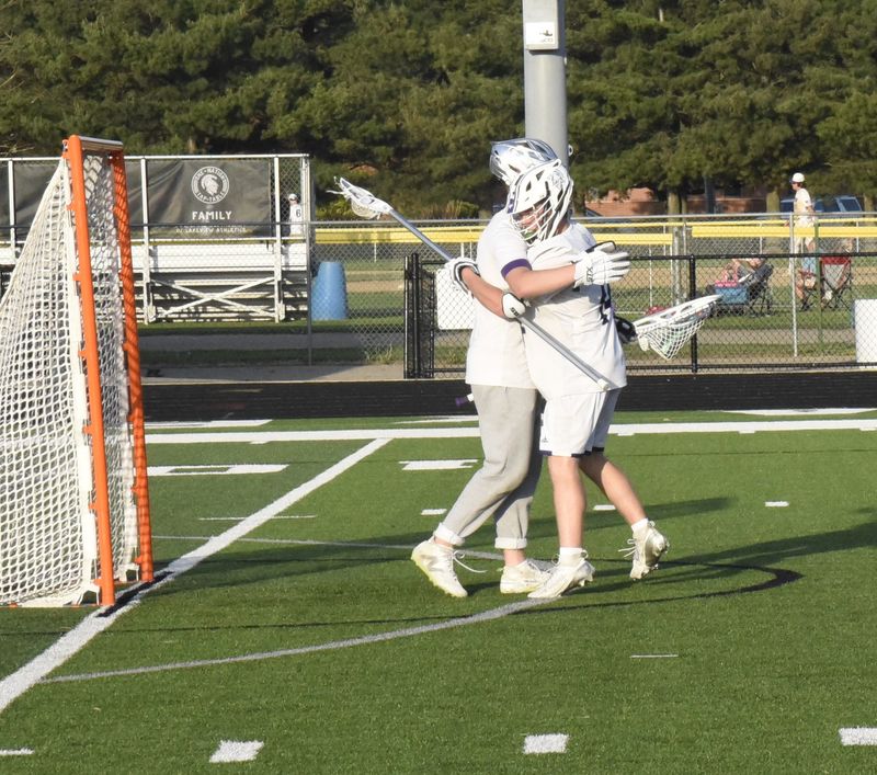 Lakeview keeper Rykert Bloch is congratulated by teammate Aiden Reed as the Spartans held on to beat Harper Creek in this first round regional boys lacrosse game at Lakeview High School on May 15, 2025.