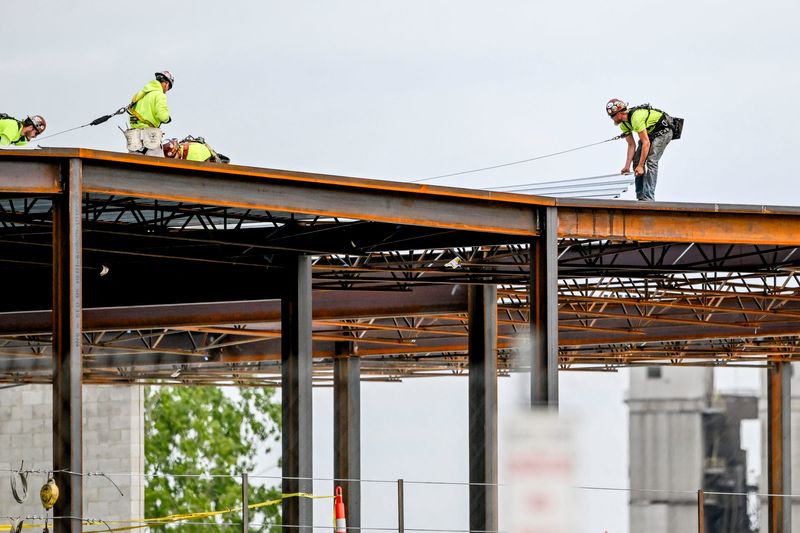 A construction crew works at the new public safety complex site on Wednesday, May 28, 2025, in Lansing.