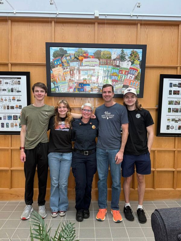 South Lyon Fire Chief Cindy Conrad (center) with her family at the South Lyon City Council meeting May 27, 2025. Conrad is the city's first female fire chief.