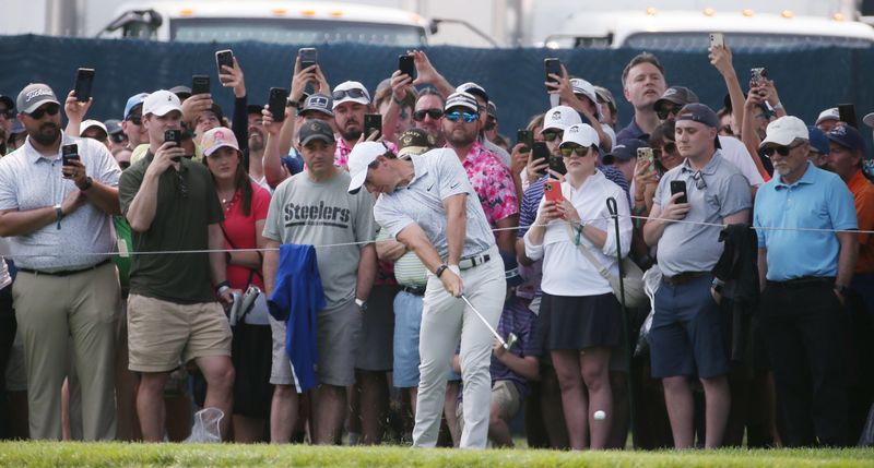 Rory McIlroy hits from the fairway rough on the 4th hole during the final round at the PGA Championship at Oak Hill Country Club Sunday, May 21, 2023.