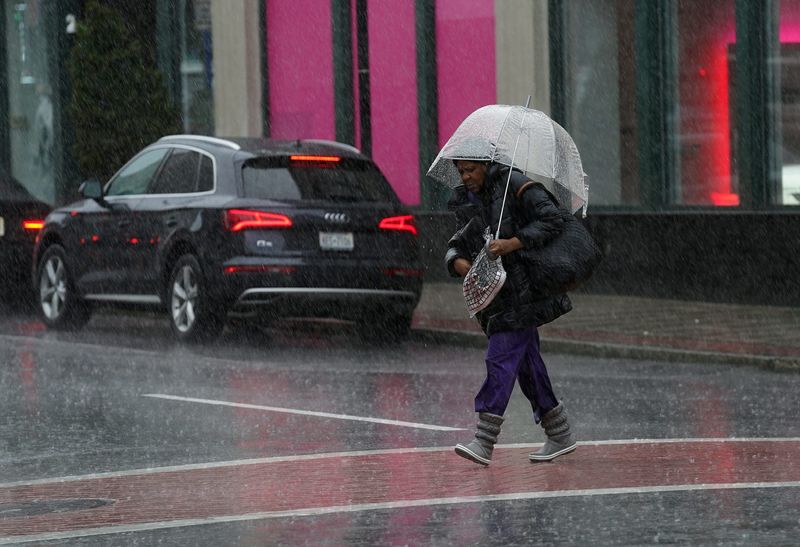 A pedestrian holding an umbrella crosses Mamaroneck Ave. in White Plains on Saturday, March 23, 2024.