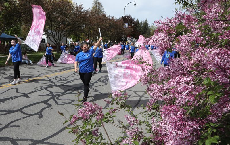 Members of the Greece Band pass by lilacs near the end of the 2024 Lilac Festival Parade route on Highland Avenue.