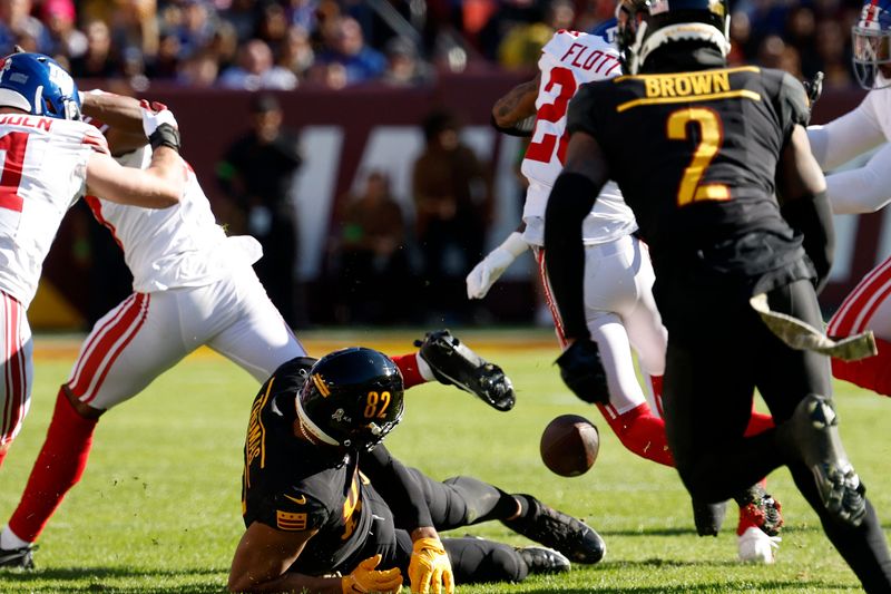 Nov 19, 2023; Landover, Maryland, USA; Washington Commanders tight end Logan Thomas (82) fumbles the ball against the New York Giants during the first quarter at FedExField. Mandatory Credit: Geoff Burke-USA TODAY Sports