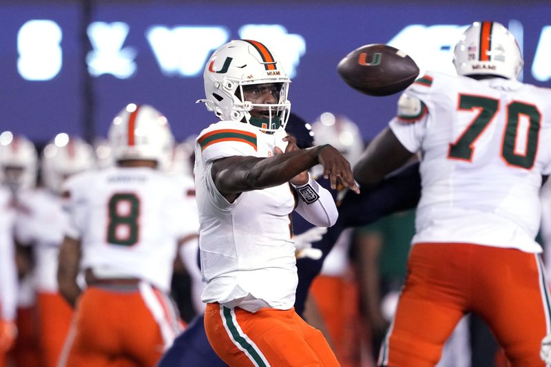 Oct 5, 2024; Berkeley, California, USA; Miami Hurricanes quarterback Cam Ward (1) throws a pass against the California Golden Bears during the first quarter at California Memorial Stadium. Mandatory Credit: Darren Yamashita-Imagn Images