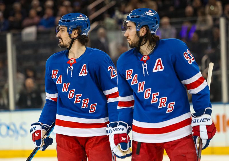 New York Rangers left wing Chris Kreider (20) and center Mika Zibanejad (93) skate against the Vancouver Canucks during the third period at Madison Square Garden.