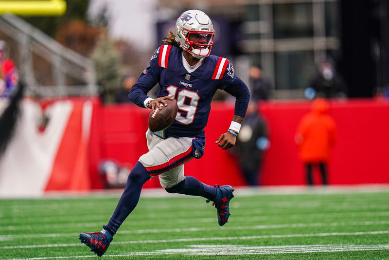 Jan 5, 2025; Foxborough, Massachusetts, USA; New England Patriots quarterback Joe Milton III (19) runs the ball against the Buffalo Bills in the first half at Gillette Stadium. Mandatory Credit: David Butler II-Imagn Images
