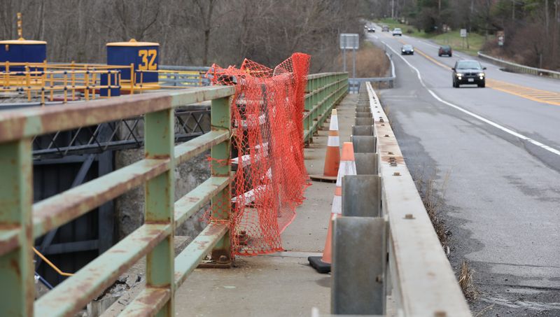 Barriers are set up blocking foot traffic over a bridge along Clover Street that spans the Erie Canalway Trail and the Erie Canal near Lock E32 in Pittsford, Monday, March 31, 2025. This is one of several bridges across Monroe County and the Rochester region that are in need of replacing according to national data from the Federal Highway Administration's National Bridge Inventory and a report released by New York State Comptroller Thomas DiNapoli in July 2024.