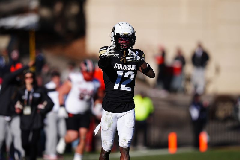 Nov 29, 2024; Boulder, Colorado, USA; Colorado Buffaloes wide receiver Travis Hunter (12) celebrates his first down reception in the fourth quarter against the Oklahoma State Cowboys at Folsom Field. Mandatory Credit: Ron Chenoy-Imagn Images