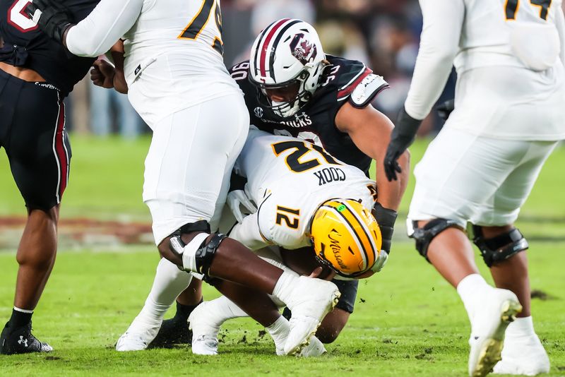 Nov 16, 2024; Columbia, South Carolina, USA; South Carolina Gamecocks defensive tackle T.J. Sanders (90) sacks Missouri Tigers quarterback Brady Cook (12) in the second quarter at Williams-Brice Stadium. Mandatory Credit: Jeff Blake-Imagn Images