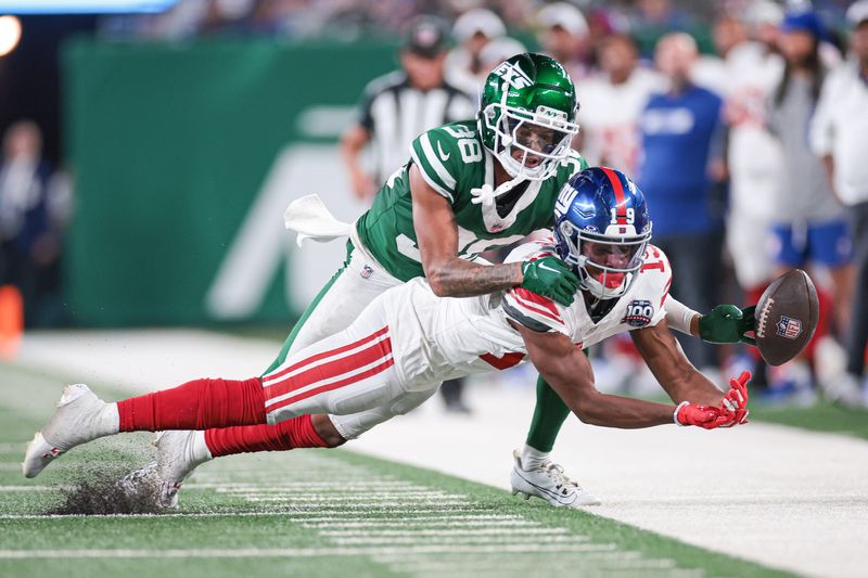 Aug 24, 2024; East Rutherford, New Jersey, USA; New York Jets defensive back Nehemiah Shelton (38) breaks up a pass intended for New York Giants wide receiver Ayir Asante (19) during the second half at MetLife Stadium. Mandatory Credit: Vincent Carchietta-USA TODAY Sports