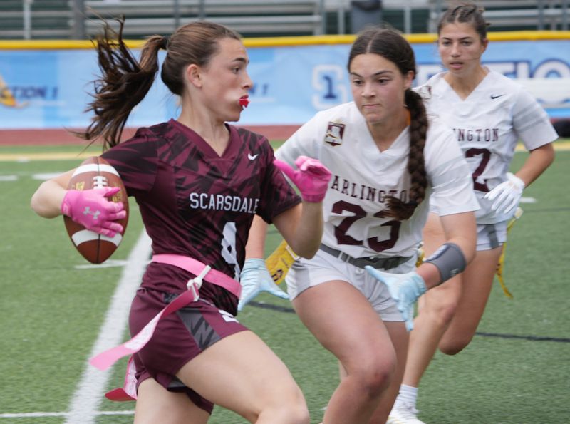 Scarsdale’s Lilly Tessler (4) looks for some running room in the Arlington defense during the Section 1 flag football Class A championship at Lakeland High School in Shrub Oak May 24, 2025. Scarsdale won the game 41-7.