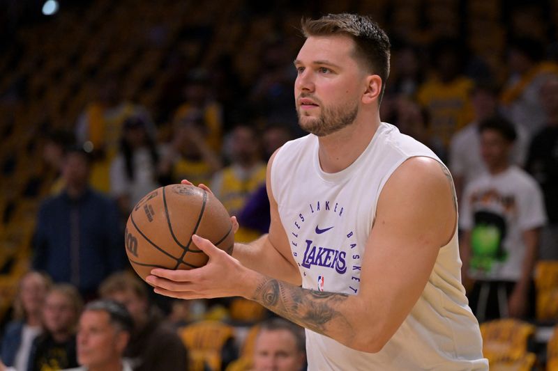FILE PHOTO: Apr 19, 2025; Los Angeles, California, USA;  Los Angeles Lakers guard Luka Doncic (77) warms up prior to the game against the Minnesota Timberwolves at Crypto.com Arena. Mandatory Credit: Jayne Kamin-Oncea-Imagn Images/File Photo