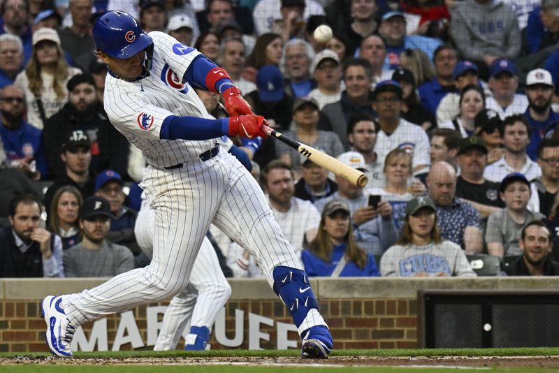 Apr 22, 2025; Chicago, Illinois, USA;  Chicago Cubs catcher Miguel Amaya (9)  hits an RBI single against the Los Angeles Dodgers during the first inning at Wrigley Field. Mandatory Credit: Matt Marton-Imagn Images